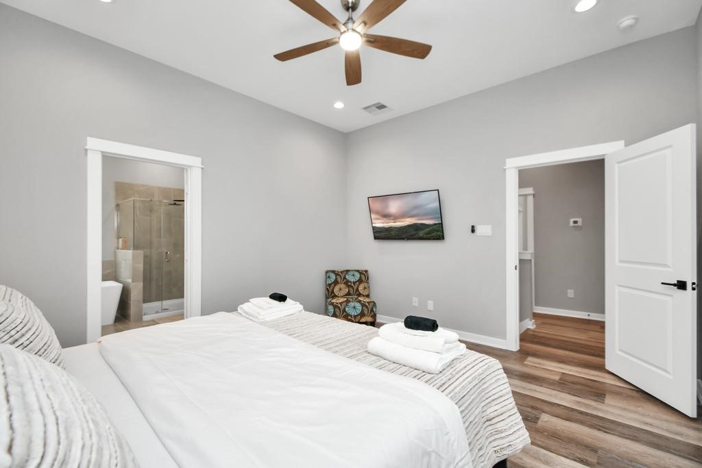 407 Stonework Oaks Lane Houston, TX 77076 - Photo 15 of 34 a bedroom with a large bed and a chandelier