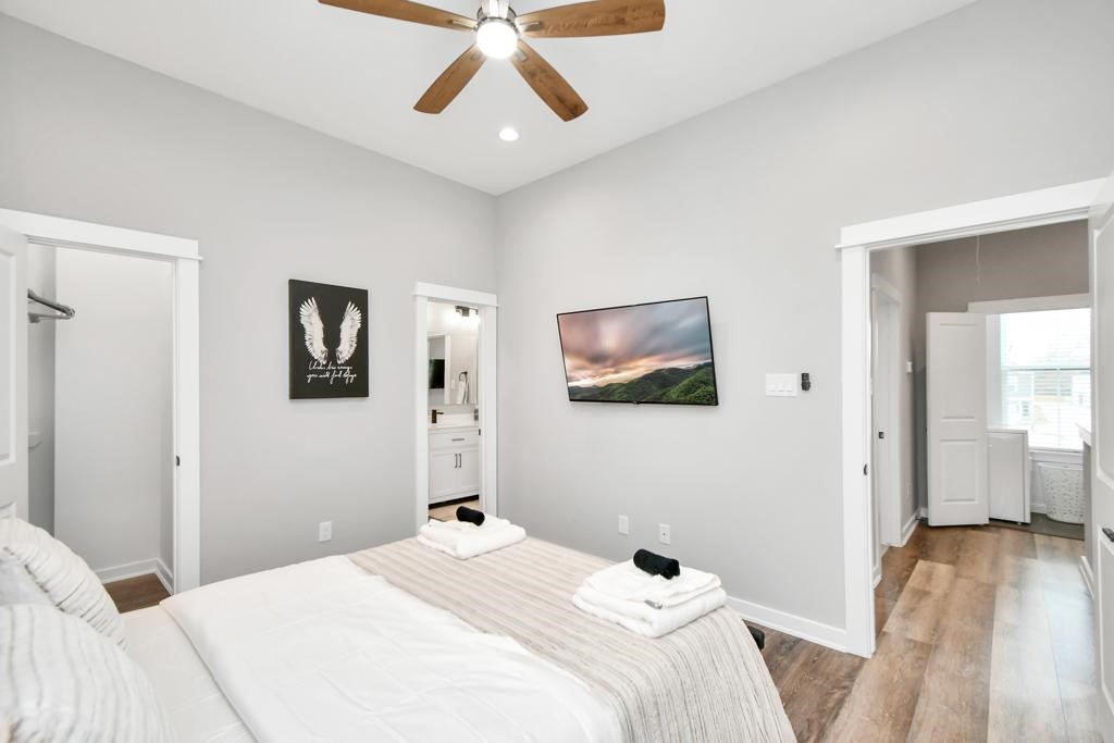 407 Stonework Oaks Lane Houston, TX 77076 - Photo 18 of 34 a bedroom with a bed and wooden floor