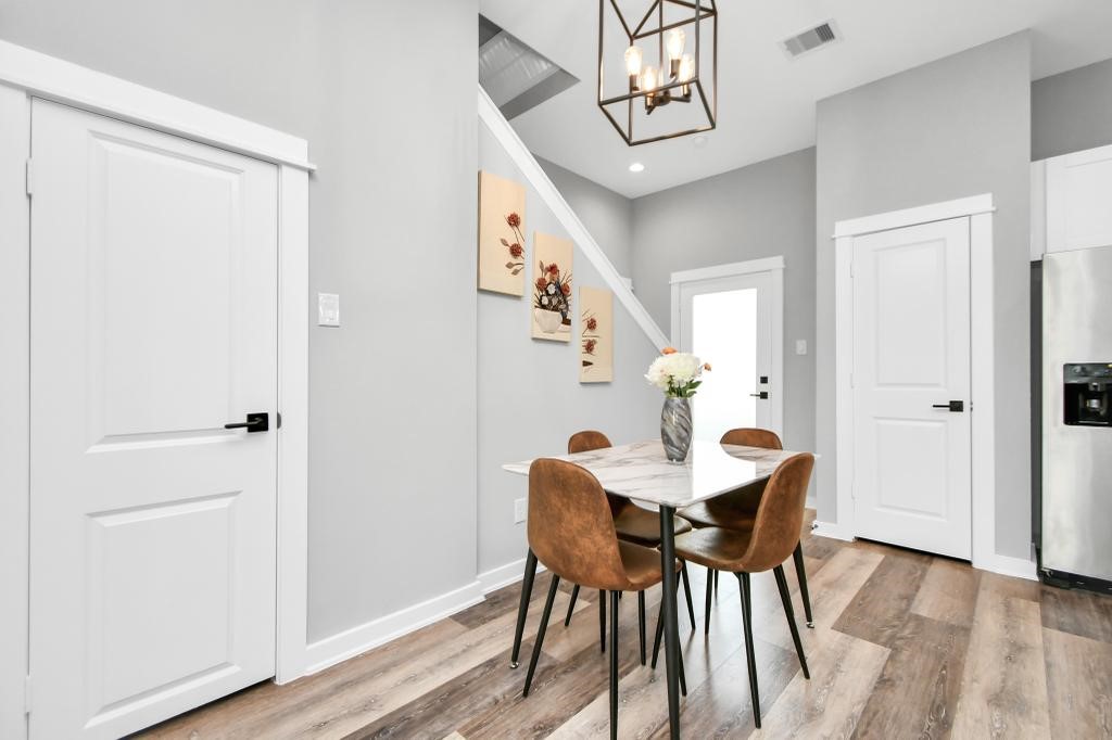 407 Stonework Oaks Lane Houston, TX 77076 - Photo 19 of 34 a view of a dining room with furniture and wooden floor