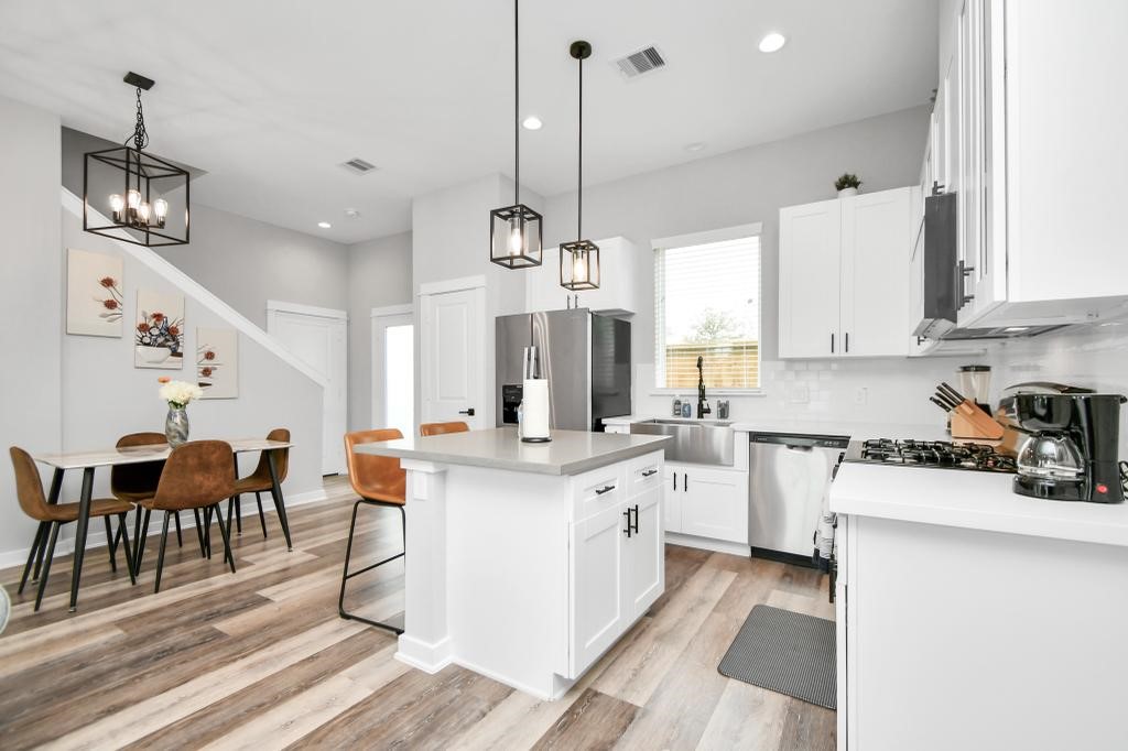 407 Stonework Oaks Lane Houston, TX 77076 - Photo 2 of 34 a large kitchen with lots of counter space and sink