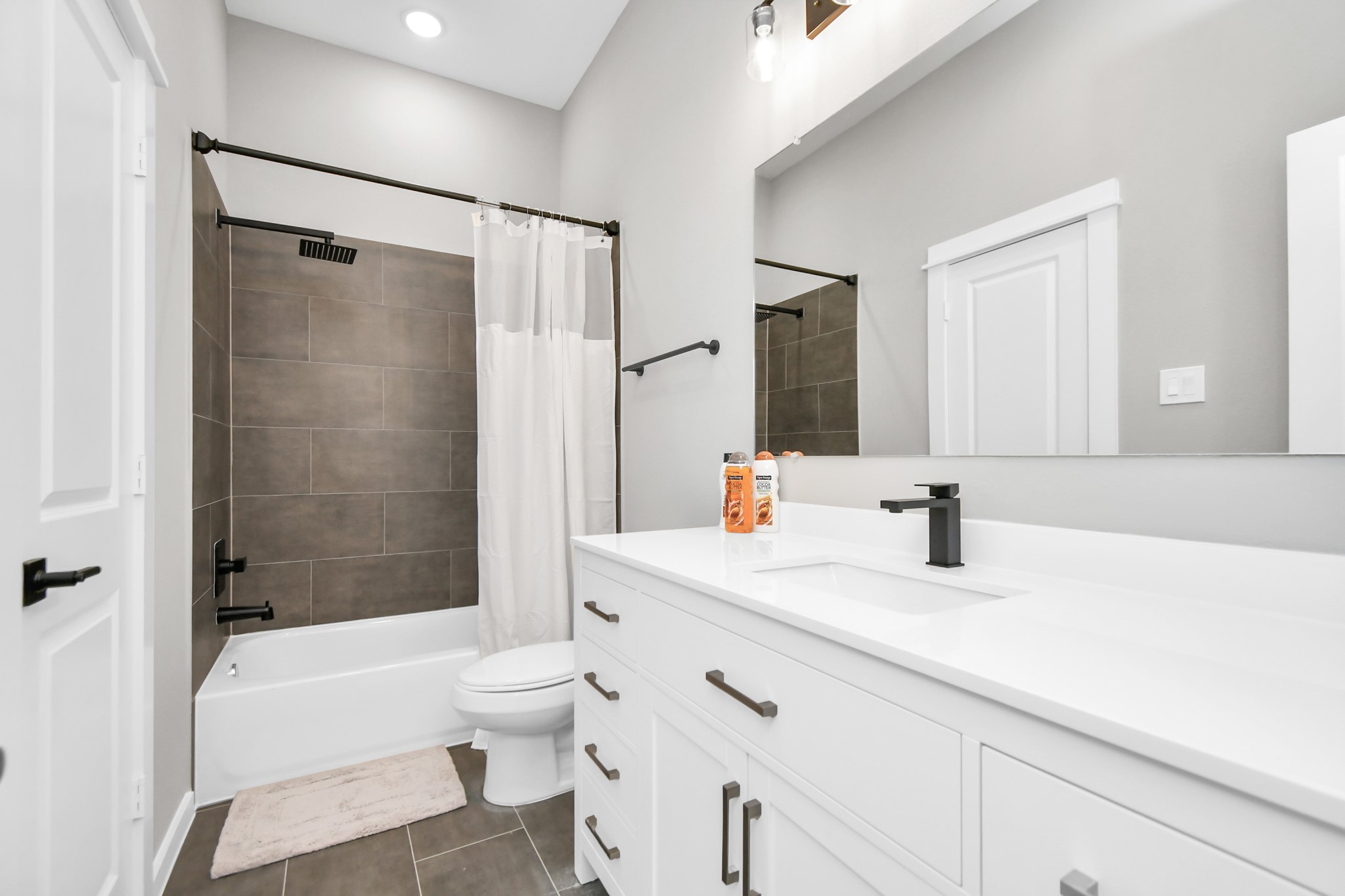 407 Stonework Oaks Lane Houston, TX 77076 - Photo 33 of 34 a bathroom with a granite countertop sink toilet and shower