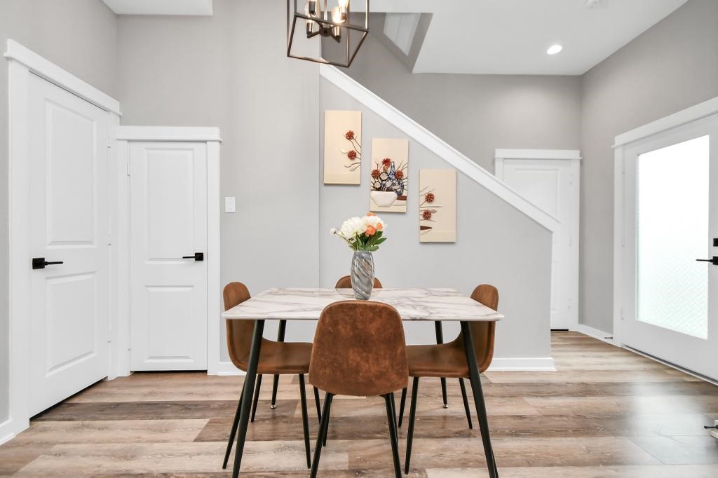 407 Stonework Oaks Lane Houston, TX 77076 - Photo 8 of 34 a view of a dining room with furniture and wooden floor