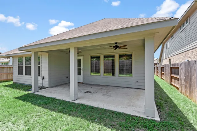 a view of a house with a porch and a yard