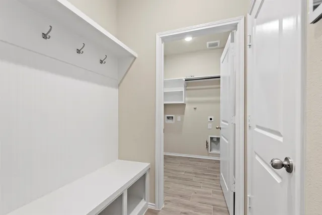 a view of a hallway with wooden floor