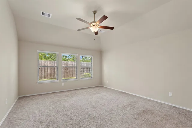 a view of a livingroom with a ceiling fan and window