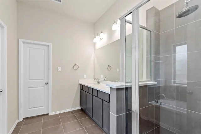 a bathroom with a shower and a sink