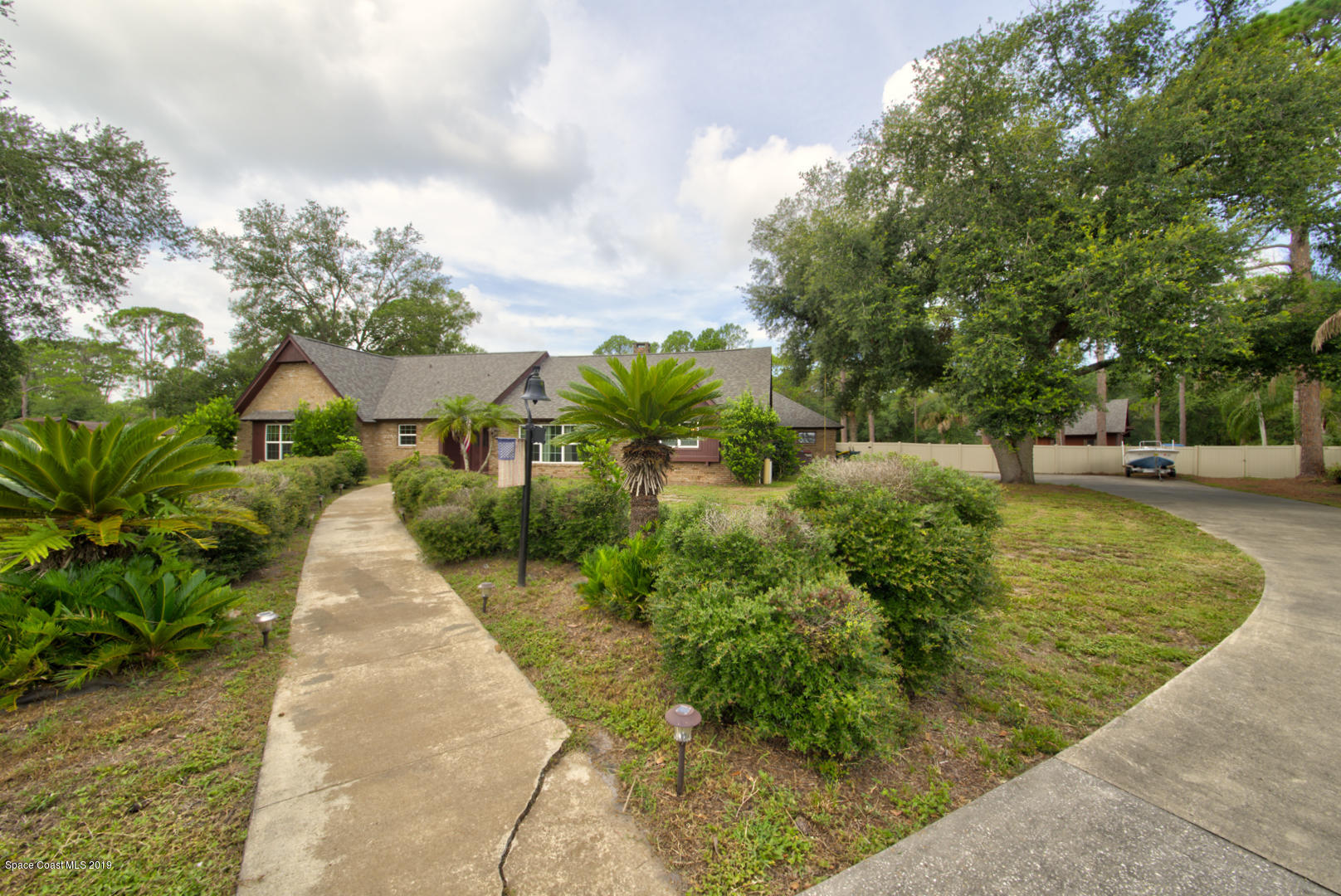 2665 Wagon Road Cocoa, FL 32926 - Photo 2 of 61 Front walkway & driveway