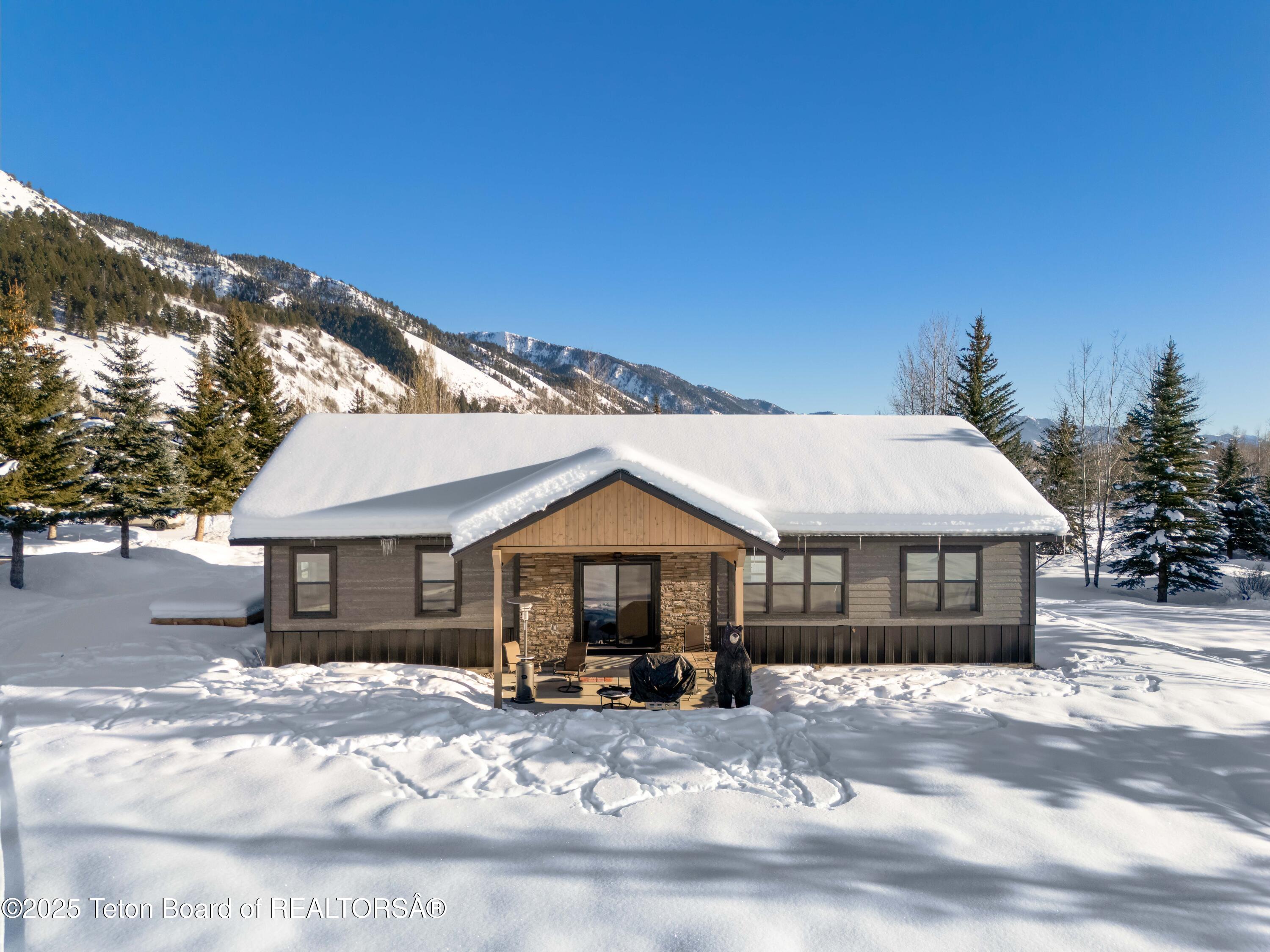 152 Porto Road Star Valley Ranch, WY 83127 - Photo 36 of 44 Back of Home from Golf Course