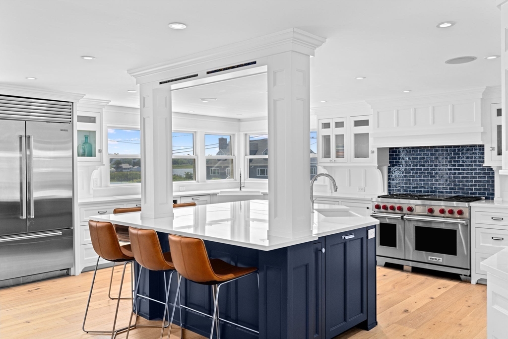 57 Surfside Road Scituate, MA 02066 - Photo 23 of 39 a kitchen with stainless steel appliances granite countertop a stove and a refrigerator