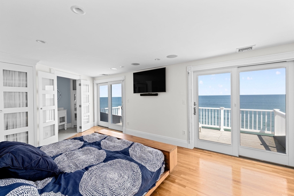 57 Surfside Road Scituate, MA 02066 - Photo 27 of 39 a bedroom with furniture and a flat screen tv