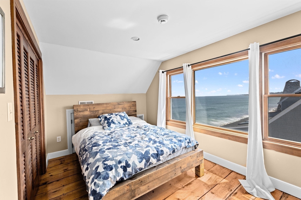 57 Surfside Road Scituate, MA 02066 - Photo 36 of 39 a bedroom with a large bed and a large window with outer view