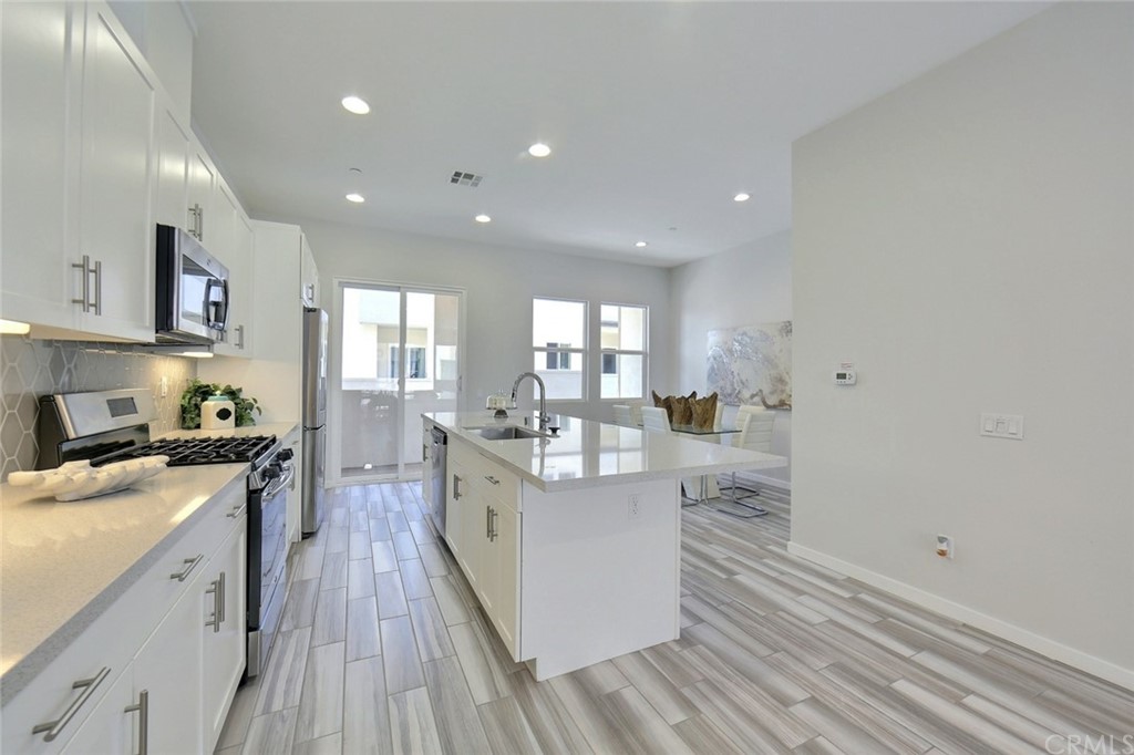 714 Brooklyn Drive Brea, CA 92821 - Photo 9 of 31 a large kitchen with stainless steel appliances granite countertop a lot of counter space and wooden floors