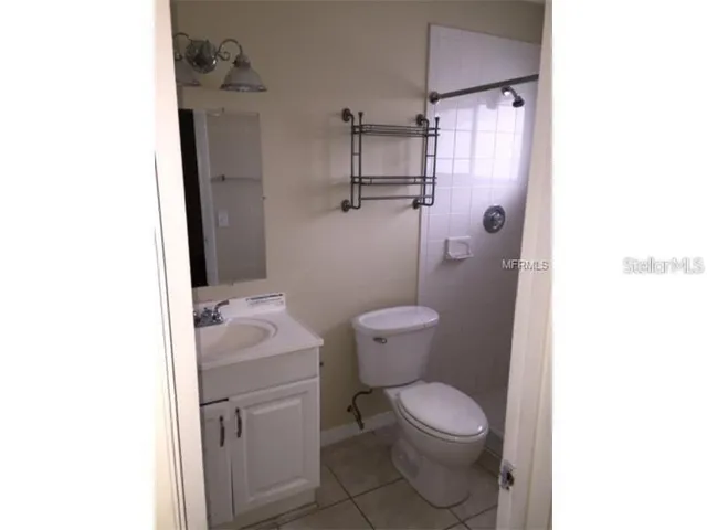 a white toilet sitting next to a bathroom sink