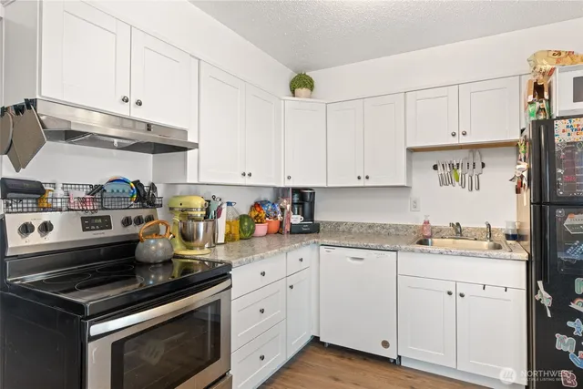 a view of a workspace with furniture and wooden floor