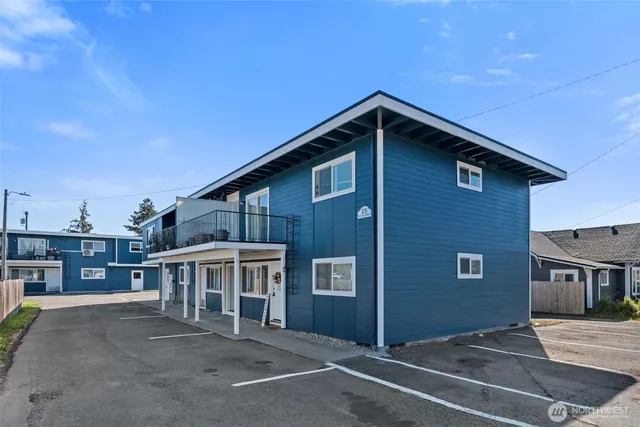 a view of a house with a patio and a yard