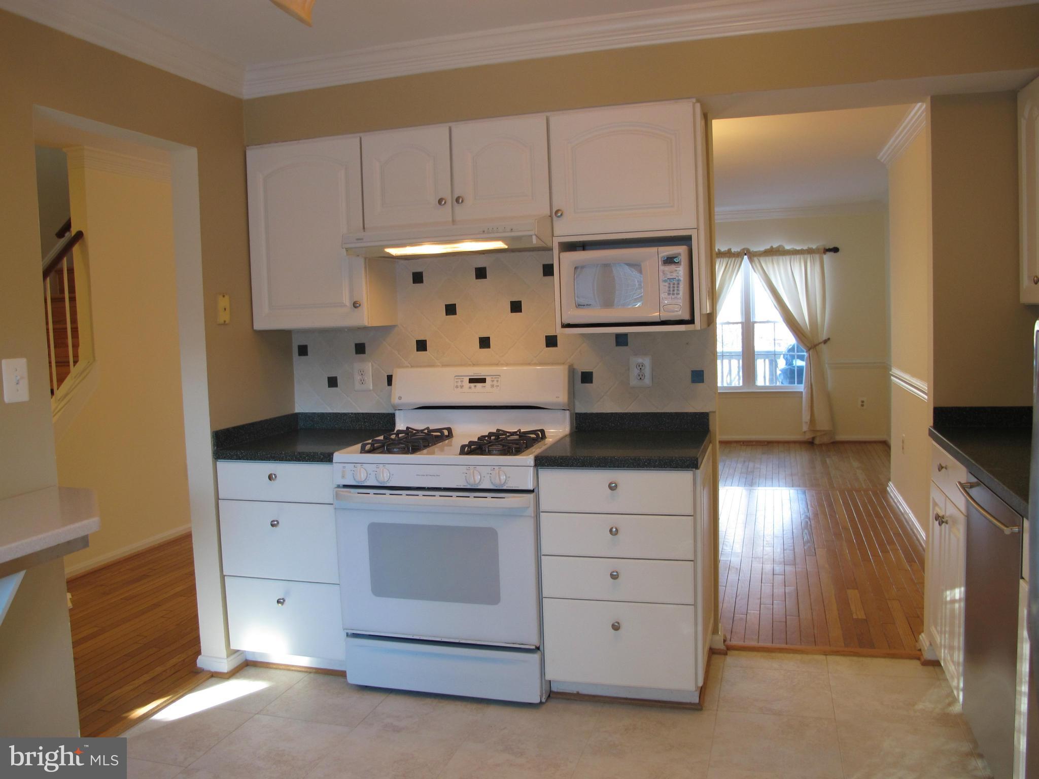 7726 Asterella Court Springfield, VA 22152 - Photo 2 of 22 a kitchen with cabinets appliances and a window