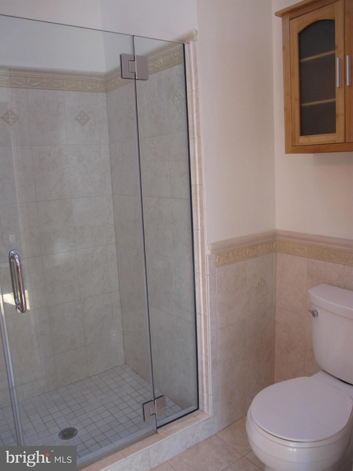 7726 Asterella Court Springfield, VA 22152 - Photo 11 of 22 a white toilet next to a bathroom