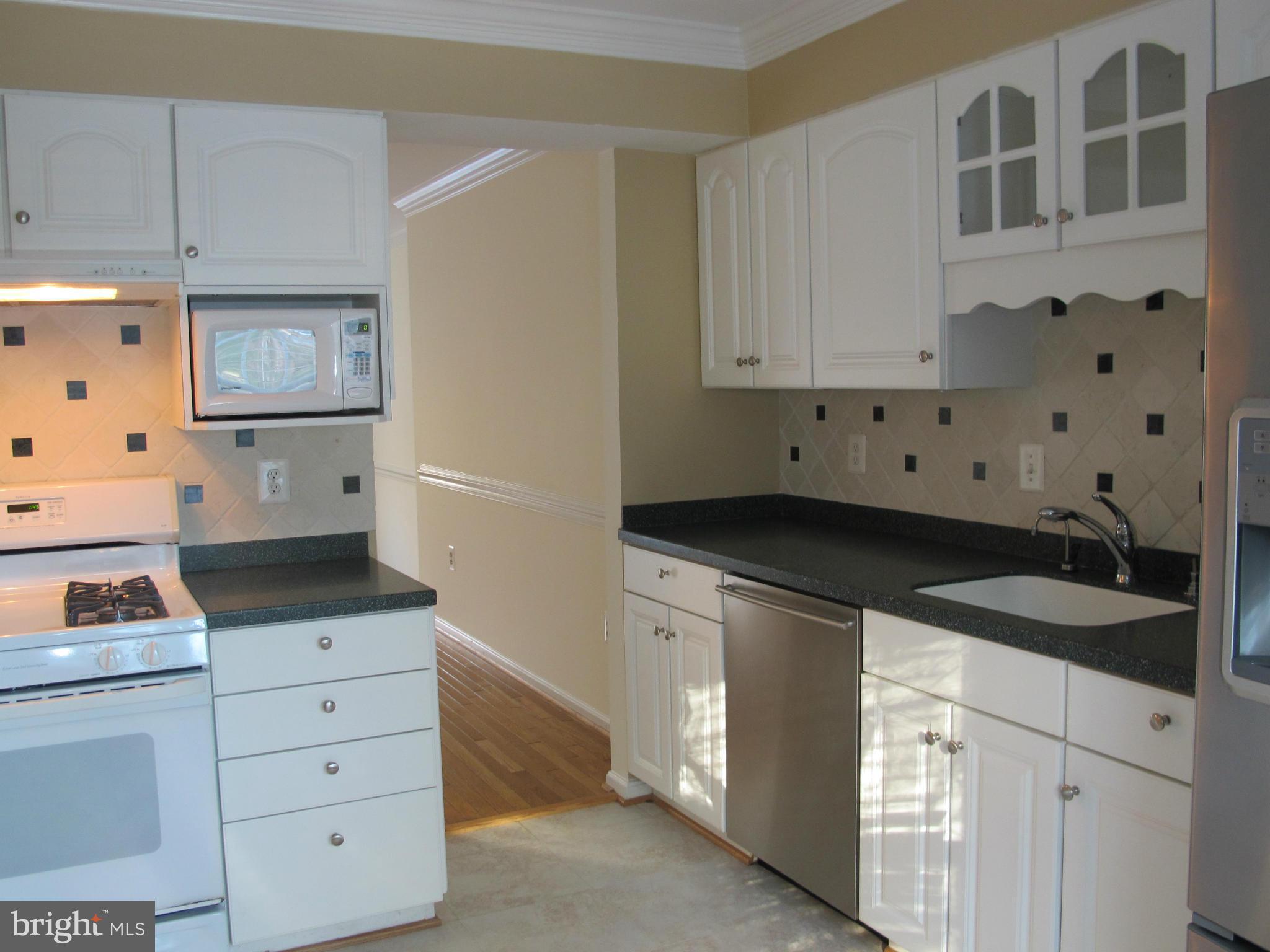 7726 Asterella Court Springfield, VA 22152 - Photo 5 of 22 a kitchen with a sink and cabinets