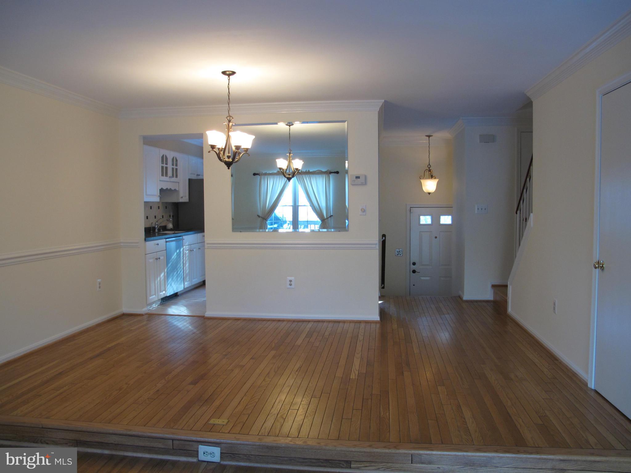 7726 Asterella Court Springfield, VA 22152 - Photo 6 of 22 an empty room with wooden floor and windows