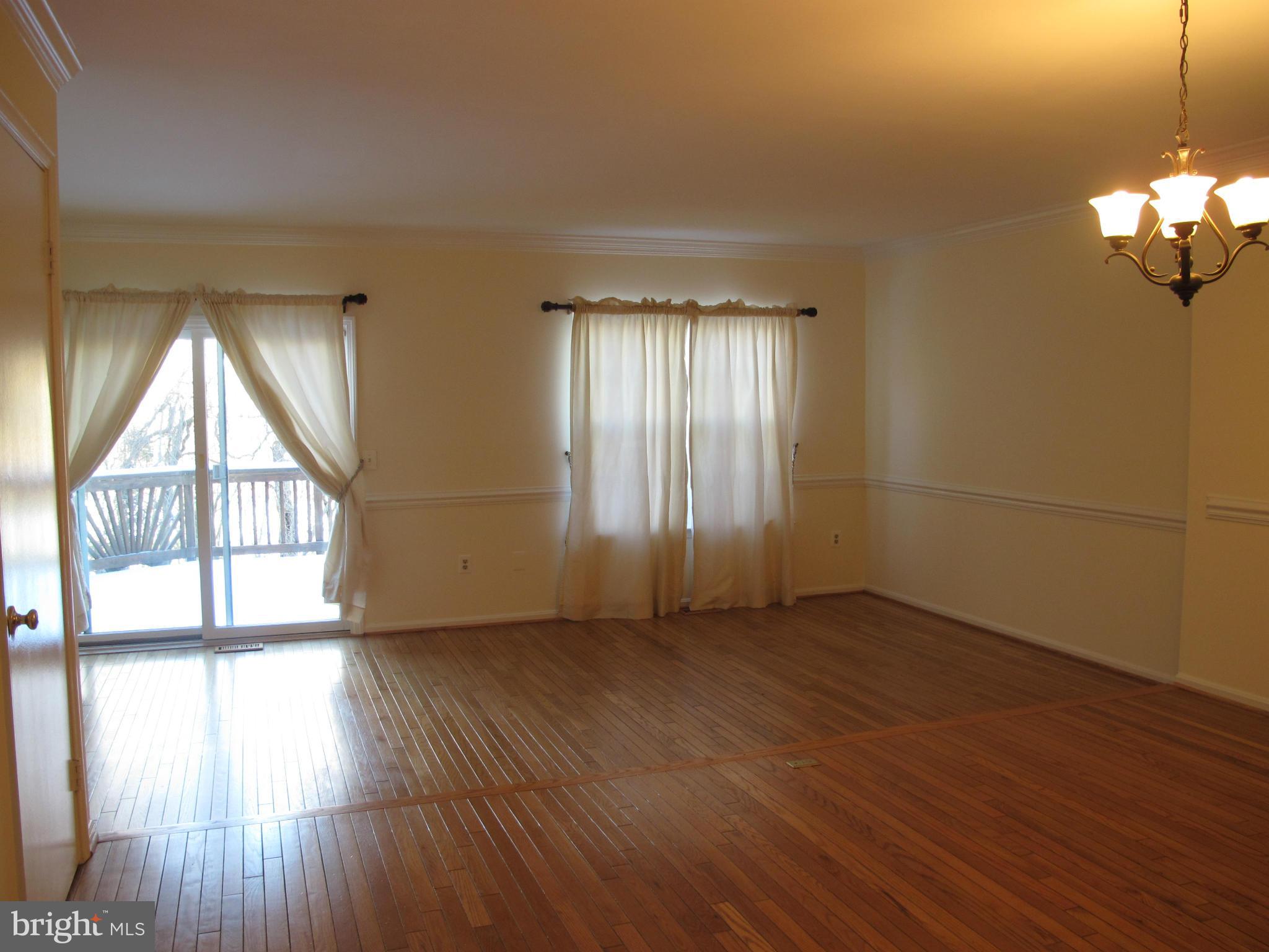 7726 Asterella Court Springfield, VA 22152 - Photo 7 of 22 an empty room with wooden floor and windows