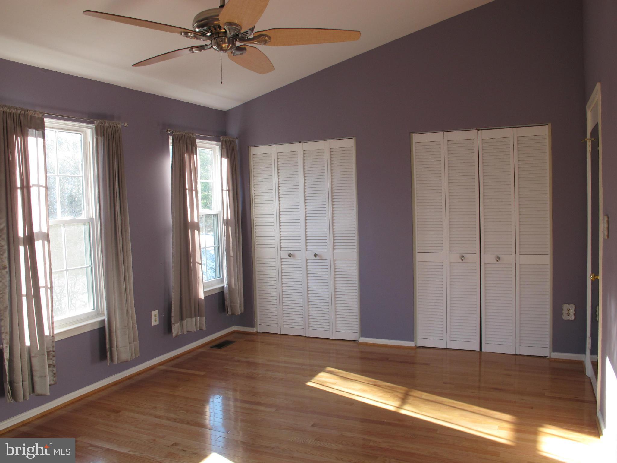 7726 Asterella Court Springfield, VA 22152 - Photo 8 of 22 a view of empty room with wooden floor and fan
