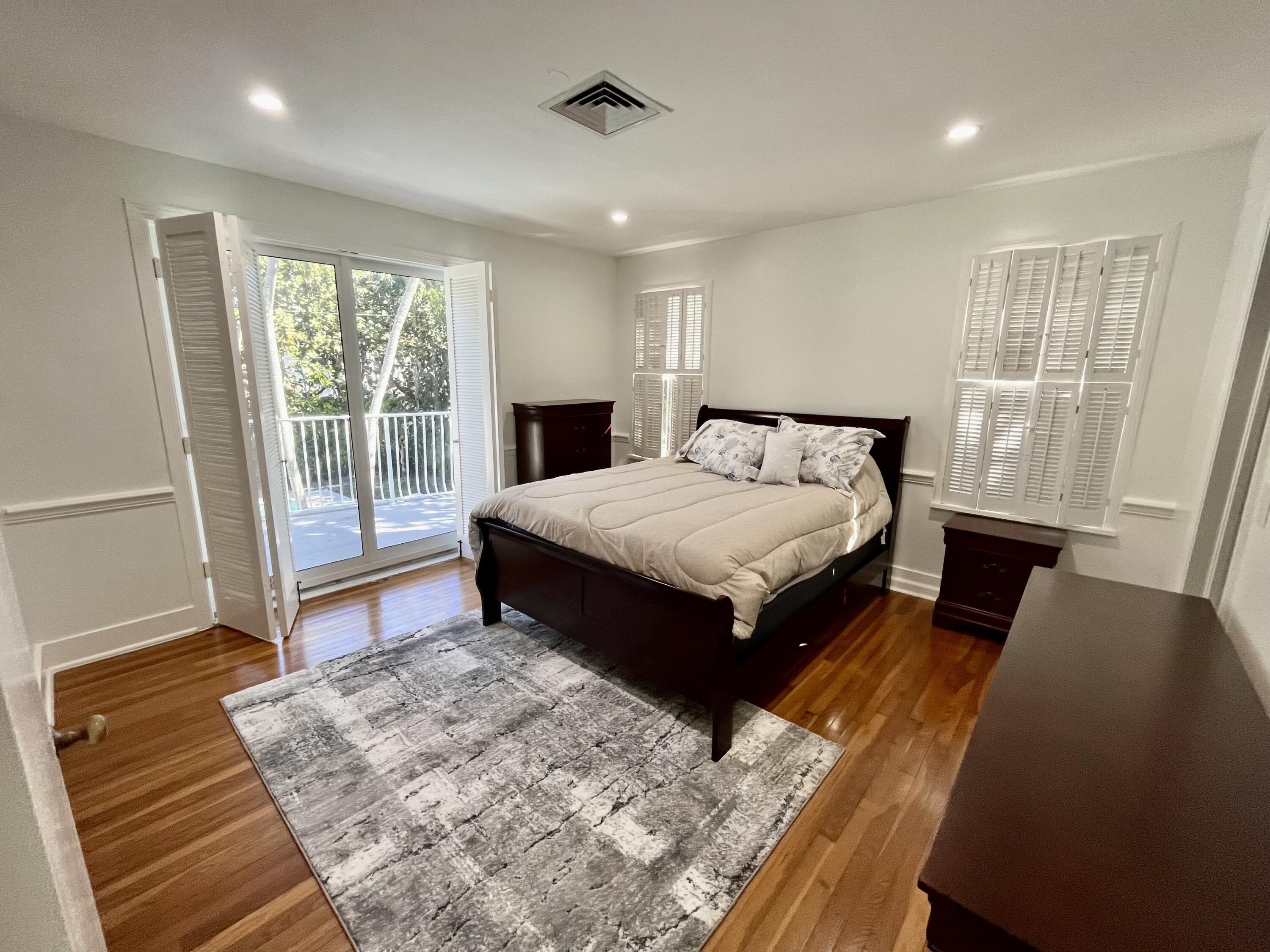 115 Dolphin Road Ocean Ridge, FL 33435 - Photo 18 of 38 a spacious bedroom with a large bed and a dresser