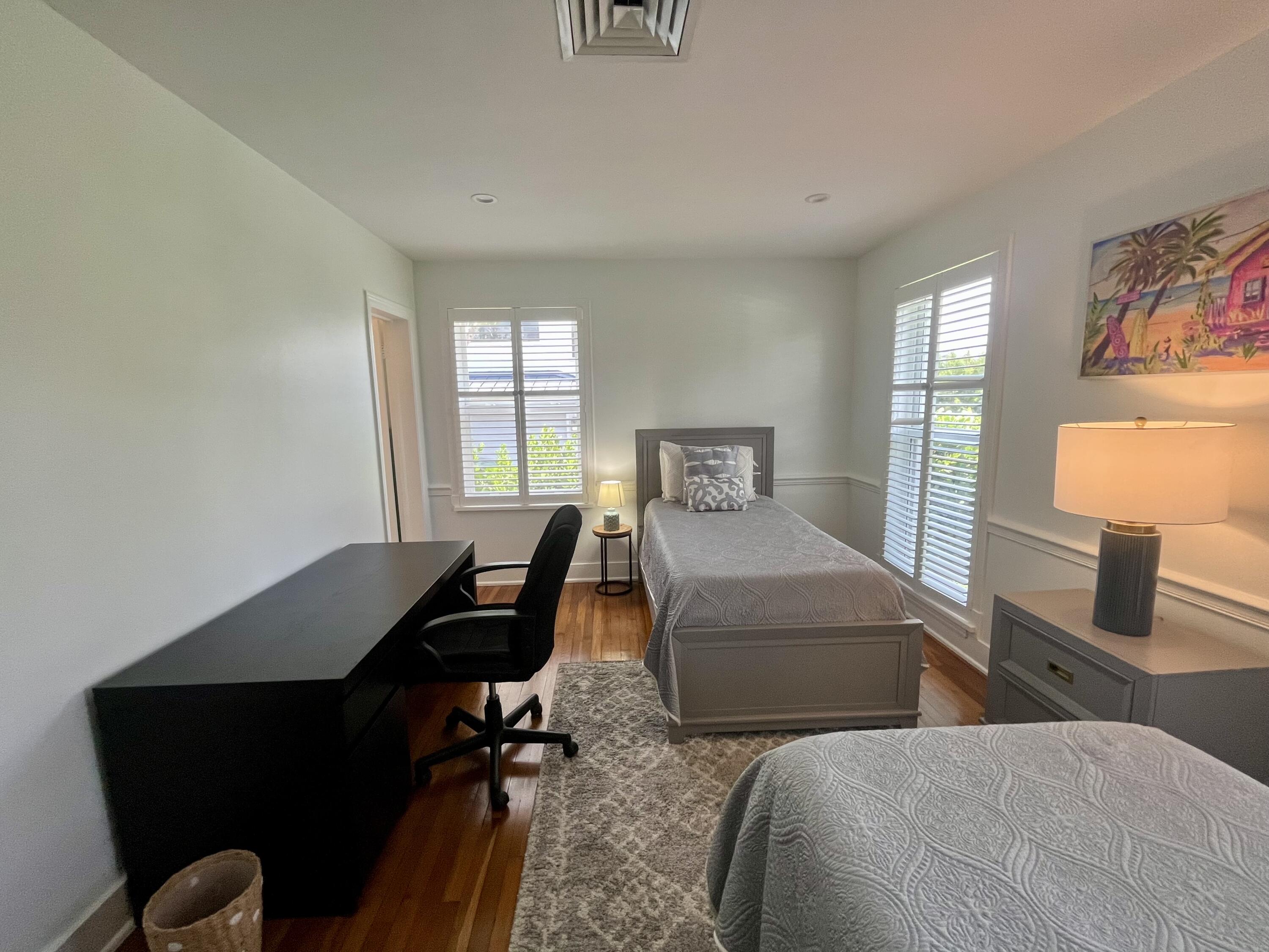 115 Dolphin Road Ocean Ridge, FL 33435 - Photo 22 of 38 a bedroom with two beds and a window