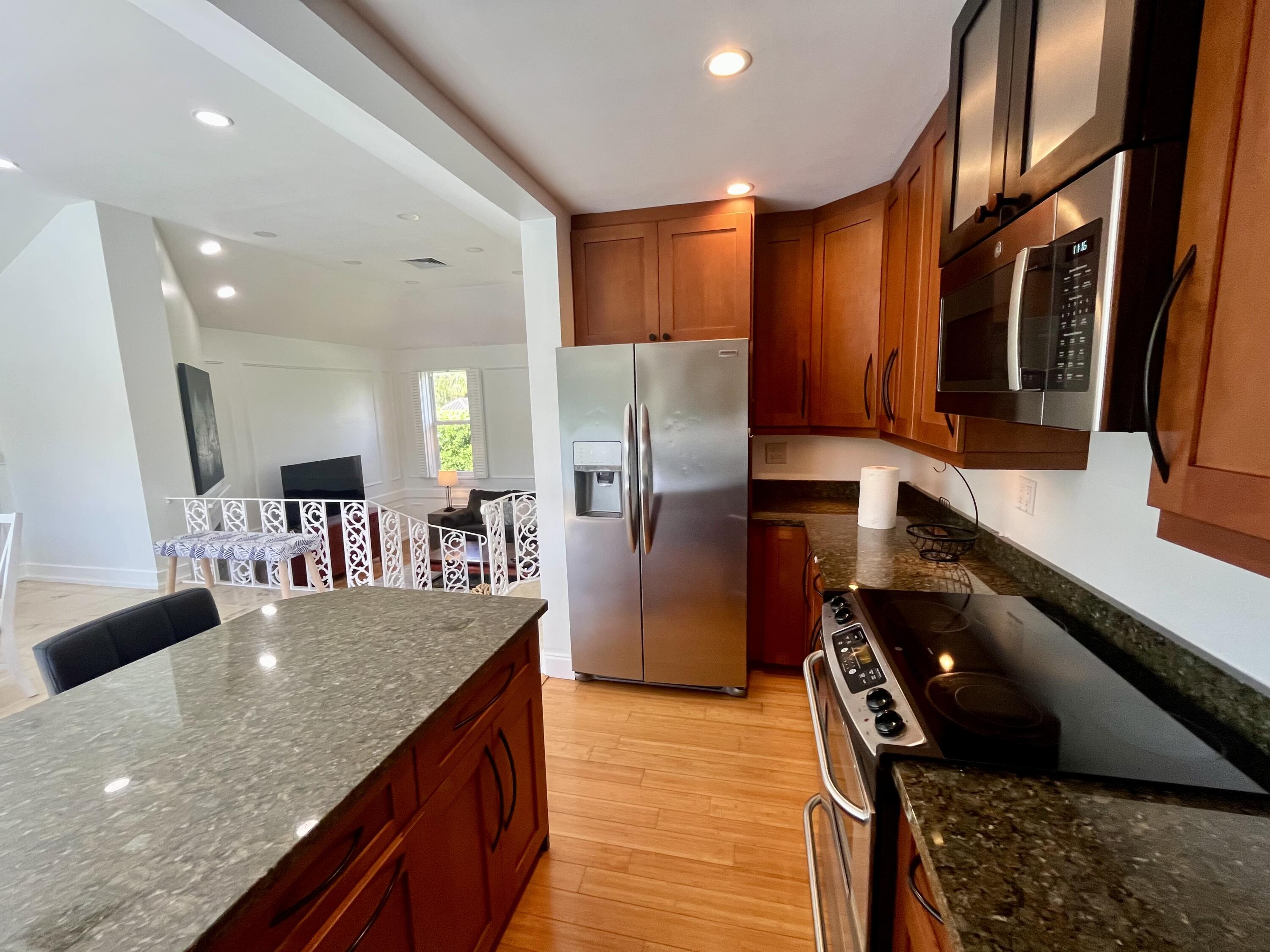 115 Dolphin Road Ocean Ridge, FL 33435 - Photo 25 of 38 a kitchen with stainless steel appliances granite countertop a refrigerator a stove and a sink
