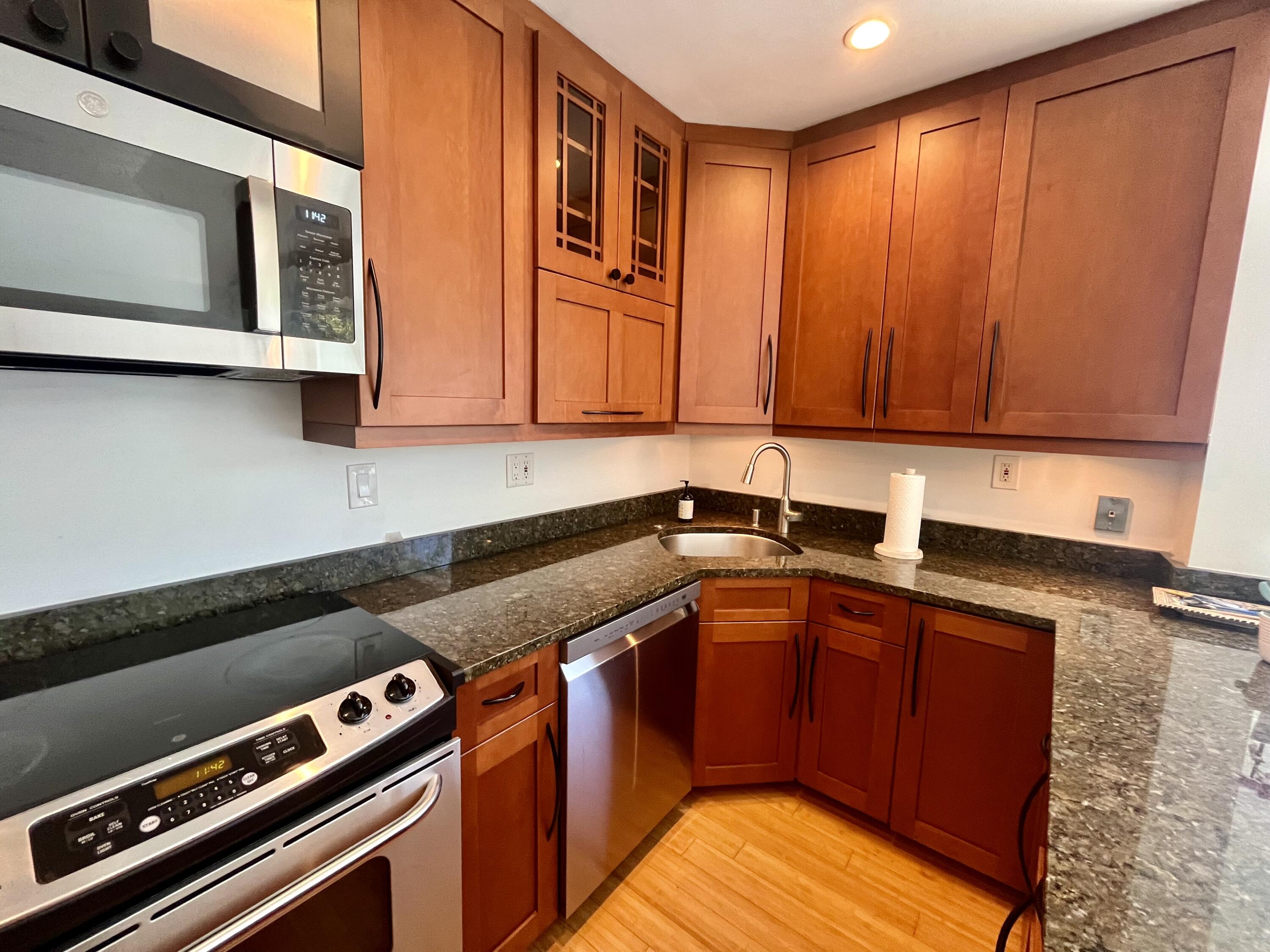 115 Dolphin Road Ocean Ridge, FL 33435 - Photo 26 of 38 a kitchen with stainless steel appliances granite countertop a stove a sink and a microwave
