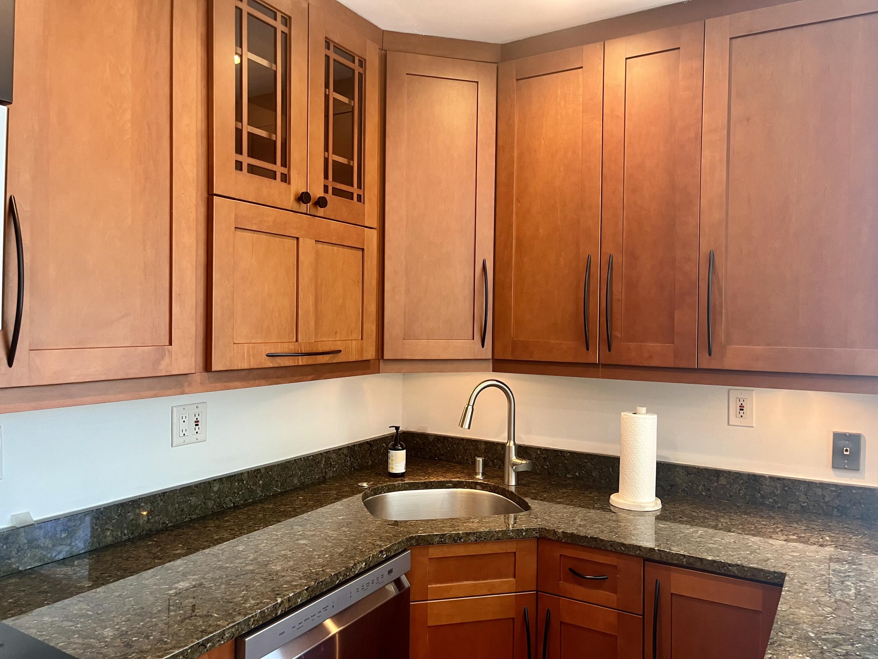 115 Dolphin Road Ocean Ridge, FL 33435 - Photo 27 of 38 a kitchen with granite countertop cabinets and sink
