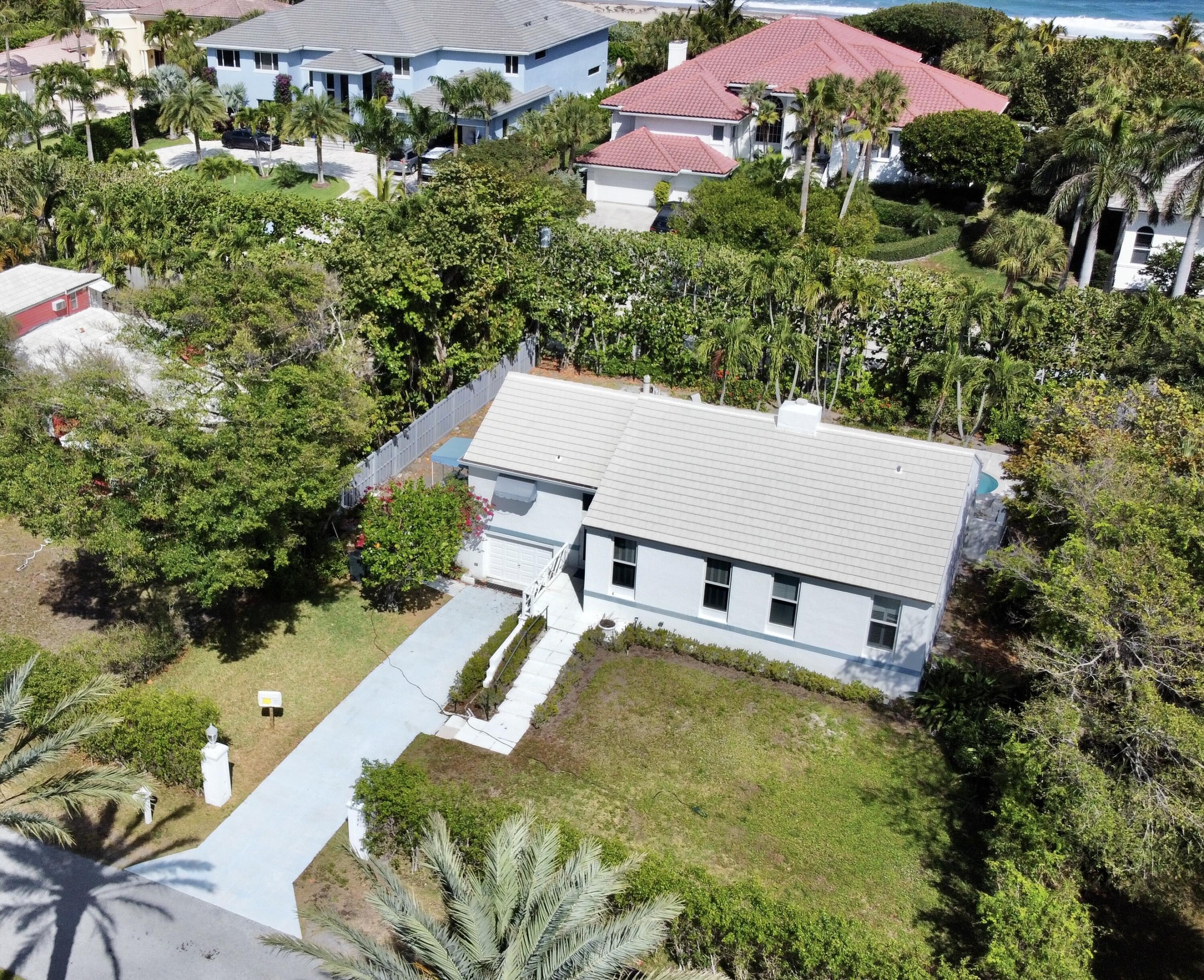 115 Dolphin Road Ocean Ridge, FL 33435 - Photo 31 of 38 an aerial view of a house with swimming pool and garden