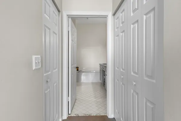 a bathroom with a granite countertop bathtub a sink and mirror
