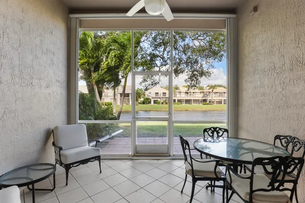 a balcony with table and chairs
