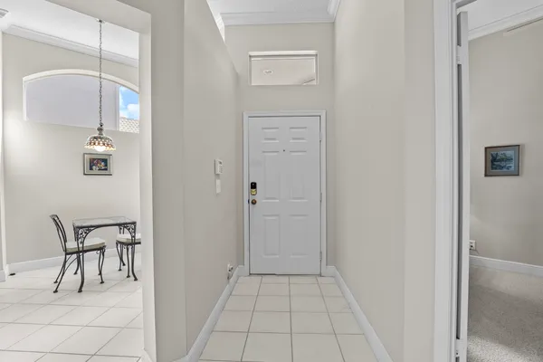 a kitchen with stainless steel appliances granite countertop a table chairs and a refrigerator