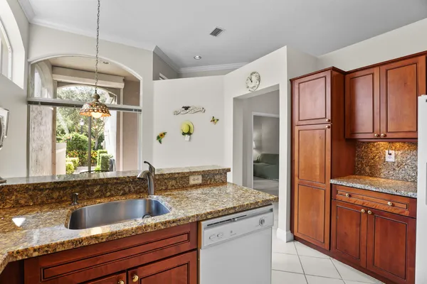a kitchen with granite countertop stainless steel appliances sink and cabinets