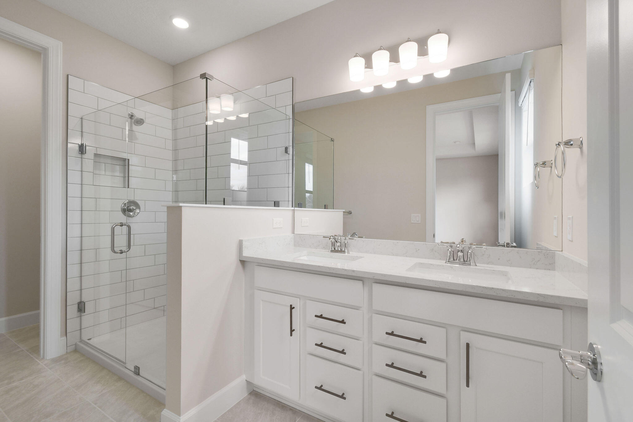 7776 Southwest Bentley Lane, Unit NAUTICAL 7414 Stuart, FL 34997 - Photo 10 of 22 a bathroom with a double vanity sink mirror and shower