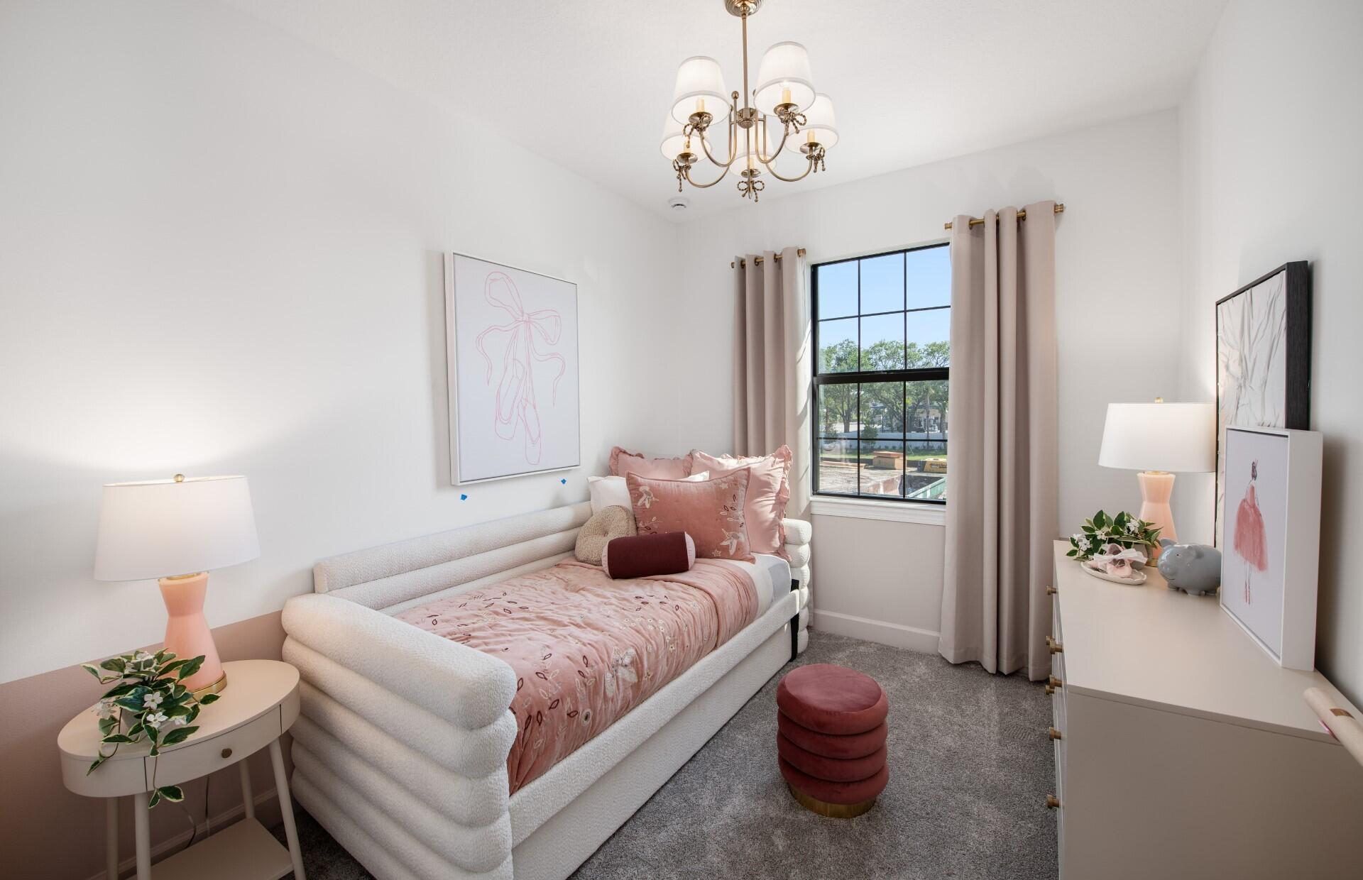 7776 Southwest Bentley Lane, Unit NAUTICAL 7414 Stuart, FL 34997 - Photo 11 of 22 a bedroom with a bed and a chandelier