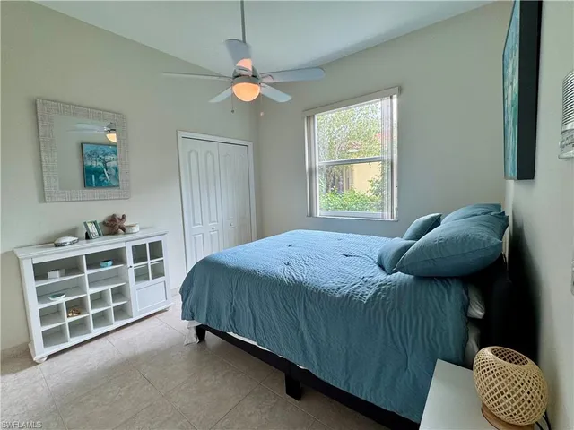 a bathroom with a granite countertop toilet sink and mirror
