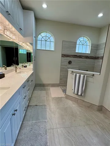 a view of a hallway with entryway wooden floor and windows
