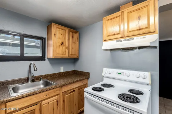 a kitchen with a stove and a sink