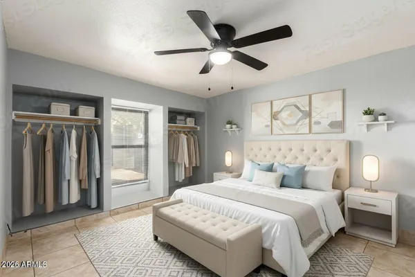 a bedroom with a large bed and a chandelier