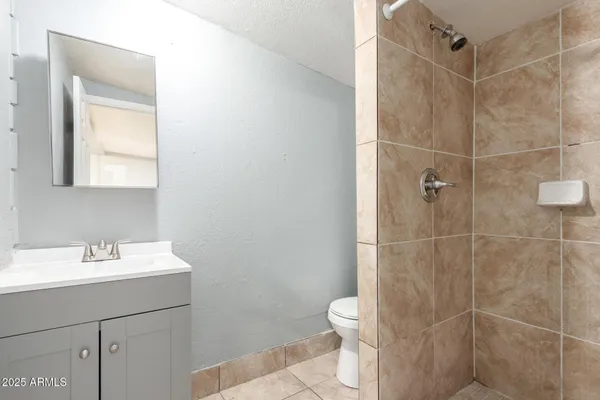 a bathroom with a sink toilet and shower