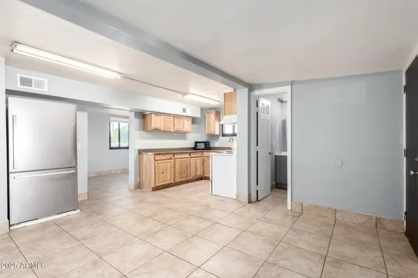 a kitchen with stainless steel appliances a refrigerator sink and cabinets