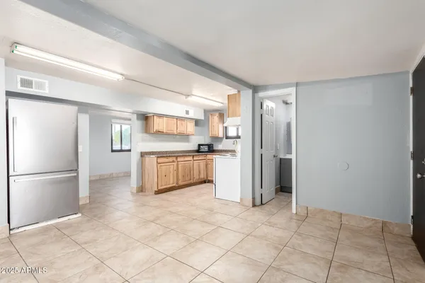 a kitchen with stainless steel appliances a refrigerator sink and cabinets