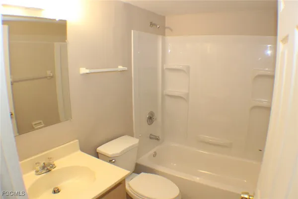 a bathroom with a bathtub shower sink and toilet