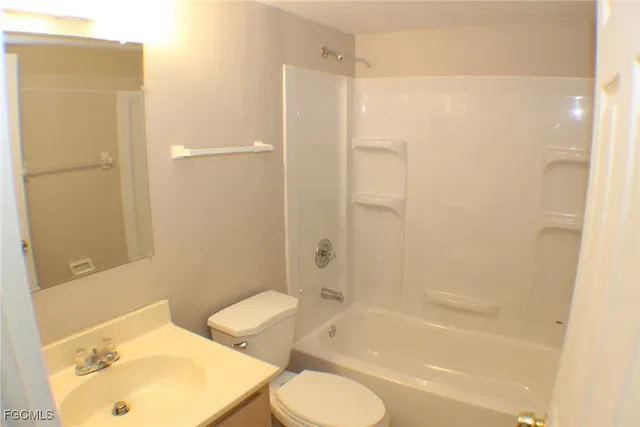 a bathroom with a bathtub shower sink and toilet