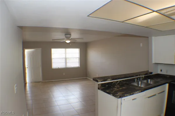 a kitchen with granite countertop a sink and a stove