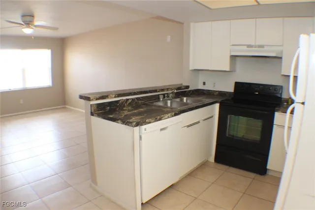 a kitchen with a stove a sink and a refrigerator