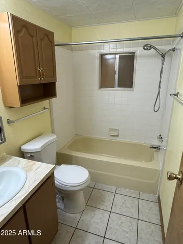 a bathroom with a toilet a sink and bathtub