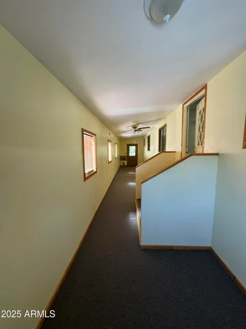 a view of a livingroom with wooden floor and stairs